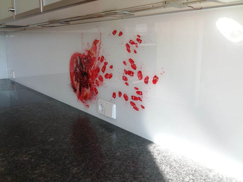 Küchenrückwand aus Glas mit digital bedruckter roter Blüte über einer dunklen Steinarbeitsplatte